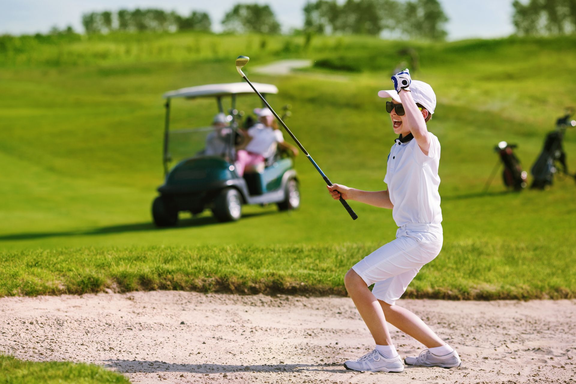 young golfer by a hole