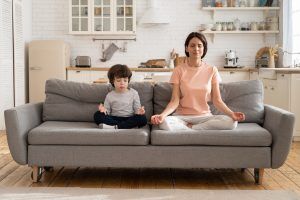 woman meditating with her son